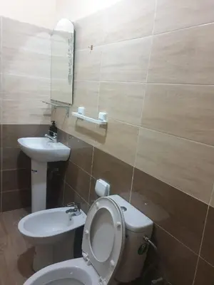 a bathroom with a toilet and a sink at Charmant appart proche Ain Asserdoun Béni Mellal in Oulad Akkou