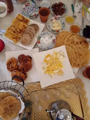 a table topped with lots of different types of food at Gite taymate in Zaouia Ben Smine
