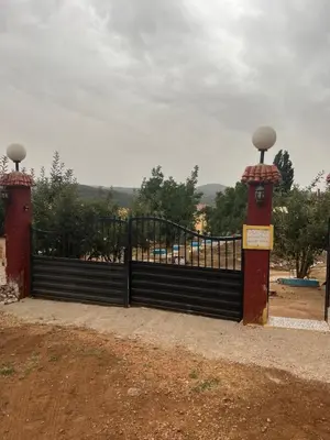 a black gate with two lights on top of it at Gite taymate in Zaouia Ben Smine