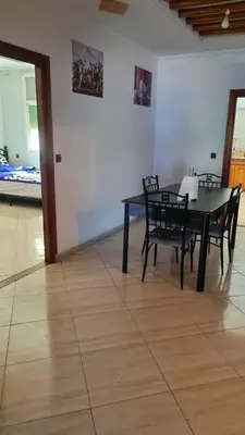 a dining room with a black table and chairs at Bel appartement en plein Taza in Taza