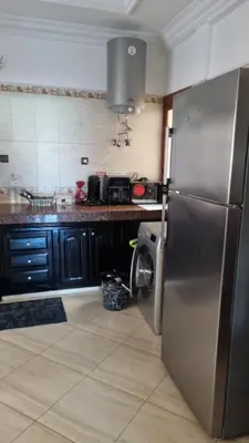 a kitchen with a stainless steel refrigerator in a kitchen at Bel appartement en plein Taza in Taza