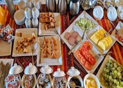 a table with many different types of food on it at Sandside Luxury Camp in Merzouga
