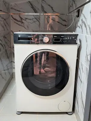 a white washing machine sitting in a room at Luxury Merzouga Appartement in Merzouga