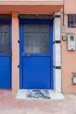 a blue door on the side of a building at Maison authentique Ourika avec vue sur l'Atlas in Ourika