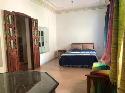 a bedroom with a bed and a glass table at Dar Kakun in Oulad Akkou