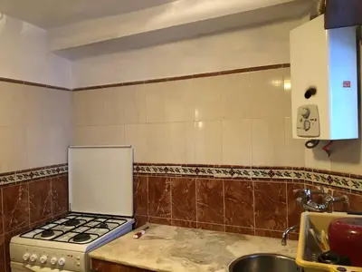 a kitchen with a stove and a sink at Dar Kakun in Oulad Akkou