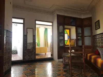 a living room with a couch and stained glass windows at Dar Kakun in Oulad Akkou