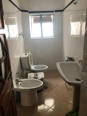 a bathroom with a toilet and a bidet and a sink at Dar Kakun in Oulad Akkou