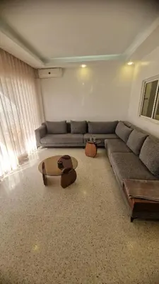 a living room with a couch and a table at Princière Downtown apartment, Fiber optic in Oulad Akkou