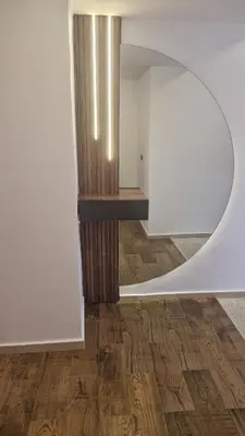 a room with a circular mirror and a wooden floor at Princière Downtown apartment, Fiber optic in Oulad Akkou
