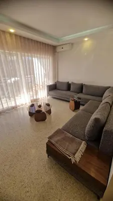 a living room with a couch and a table at Princière Downtown apartment, Fiber optic in Oulad Akkou