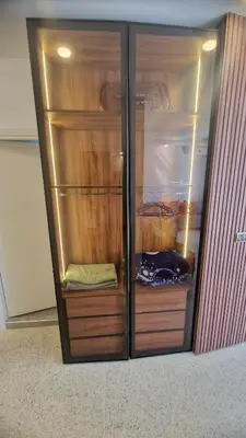 a large wooden closet with wooden shelves in it at Princière Downtown apartment, Fiber optic in Oulad Akkou