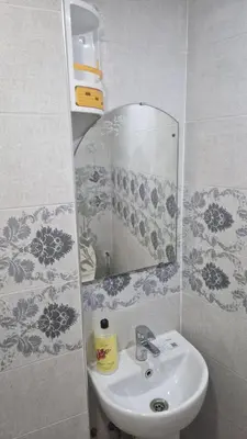 a bathroom with a sink and a mirror at Princière Downtown apartment, Fiber optic in Oulad Akkou