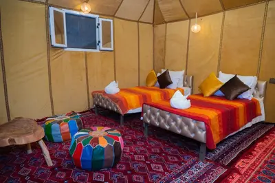 a room with three beds in a tent at Luxury Queen Camp in Tisserdmine