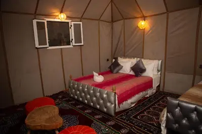 a bedroom with a bed in a tent at Luxury Queen Camp in Tisserdmine