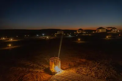 a view of a field at night with lights at Luxury Queen Camp in Tisserdmine