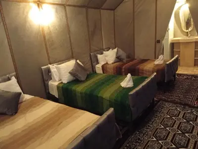 a room with three beds in a tent at Luxury Queen Camp in Tisserdmine