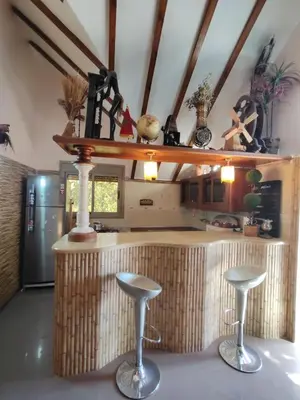a kitchen with a counter with two stools at Appartement de céder in Azrou