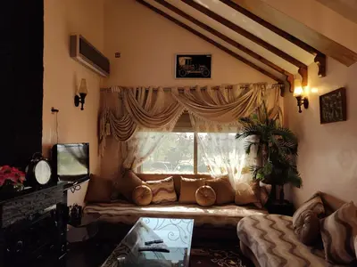 a living room with a couch in front of a window at Appartement de céder in Azrou