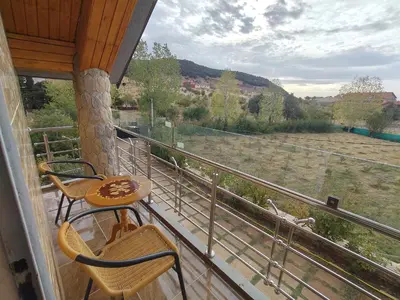 a balcony with chairs and a table and a view of a field at Appartement de céder in Azrou