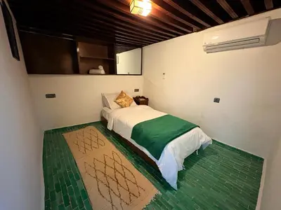a small bedroom with a bed in a room at Riad Dar Mazaj Fes in Fès