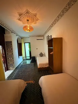 a hotel room with two beds and a star on the ceiling at Riad Dar Mazaj Fes in Fès
