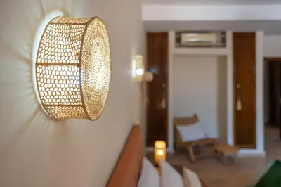 a lamp hanging on a wall in a room at Hacienda de Julie in Sraïri