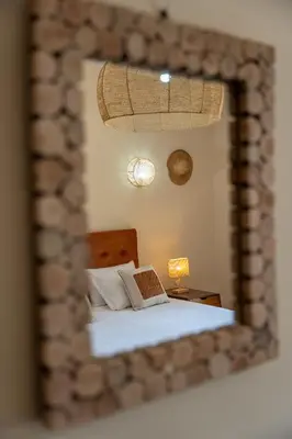 a mirror reflection of a bed in a bedroom at Hacienda de Julie in Sraïri