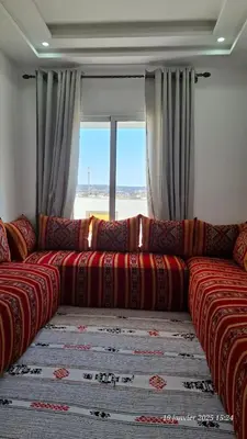 a large couch in a room with a window at maison 83 in Oulad Akkou