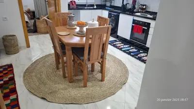 a wooden table and chairs in a kitchen at maison 83 in Oulad Akkou