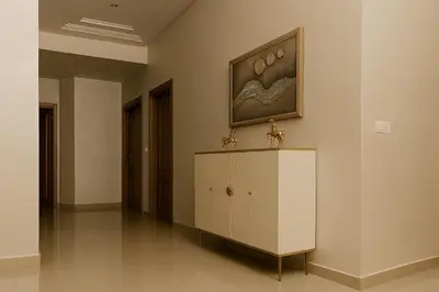 a white cabinet in a room with a painting on the wall at Nakal in Fès