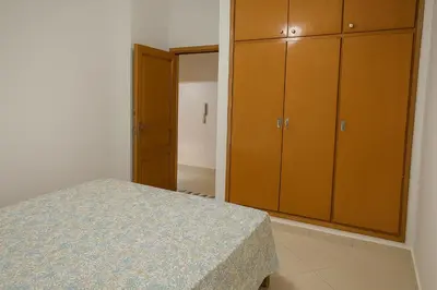 a bedroom with a bed and some wooden cabinets at Nakal in Fès