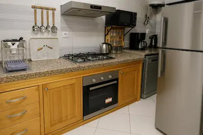 a kitchen with a stove and a refrigerator at Nakal in Fès