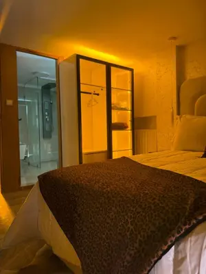 a bedroom with a bed and a bathroom with a shower at Illy house in Ifrane
