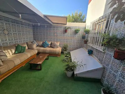 a patio with a couch and a table at Narjiss Hostel in Fès