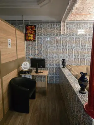 a room with a desk and a computer on a wall at Narjiss Hostel in Fès