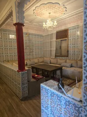 a living room with a couch and a table at Narjiss Hostel in Fès