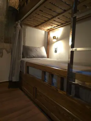 a bedroom with a wooden bed in a room at Narjiss Hostel in Fès