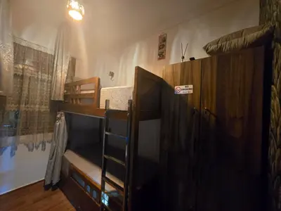 a room with two bunk beds and a ladder at Narjiss Hostel in Fès