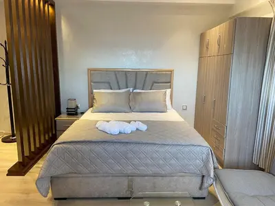 a bedroom with a bed with two towels on it at Appartement T4 in Taza