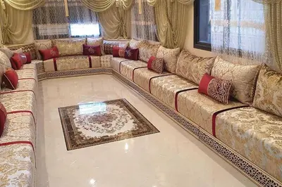 a living room with a long couch with red pillows at Appartement T4 in Taza