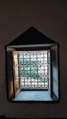 a window in a building with a metal grate at Tamrdulte in Tinerhir