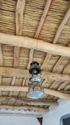 a light hanging from the ceiling of a building at Tamrdulte in Tinerhir