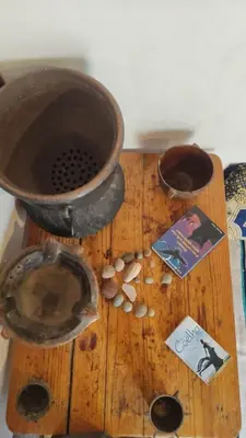 a wooden cutting board with a bowl and a book at Tamrdulte in Tinerhir
