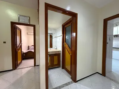 two doors in a room with a bathroom at Appartement Spacieux résidence privée surveiller in Fès