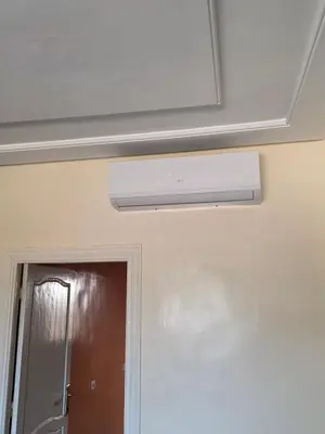 a ceiling fan in a room with a door at andalus in Fès