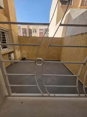 a metal stair case in a building with a window at andalus in Fès
