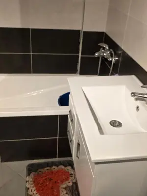 a bathroom with a white sink and a bath tub at andalus in Fès