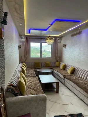 a living room with a large couch and a table at Absolute Calm & Panoramic Views in Oulad Akkou