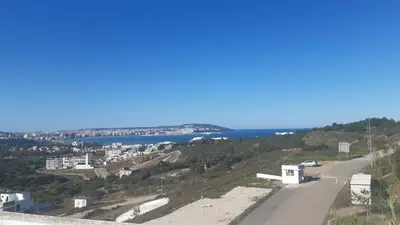 a road with a view of a city and the ocean at Absolute Calm & Panoramic Views in Oulad Akkou